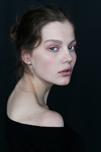 a woman with blue eyes is posing for a photo