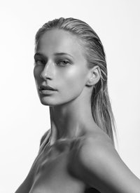 a black and white photo of a woman in a bikini