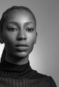 black and white photo of a woman with braids